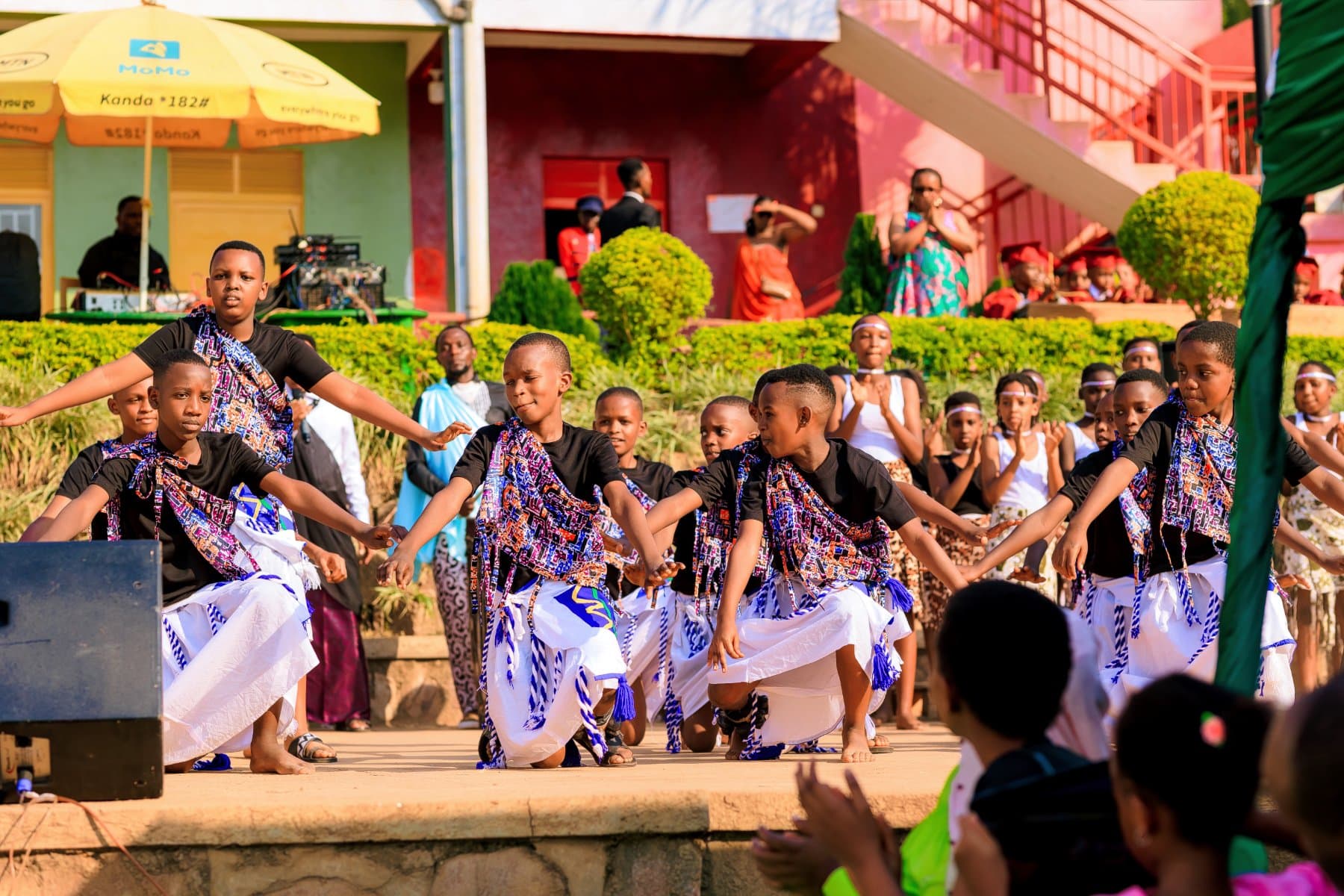 Pupils performing a traditional dance in patterned costume